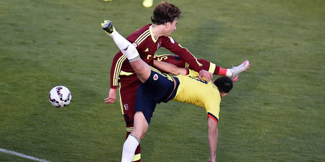 El venezolano Fernando Amorebieta frena al colombiano James Rodríguez, en Rancagua.